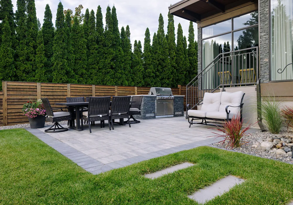 bbq stone patio and chairs and walkway