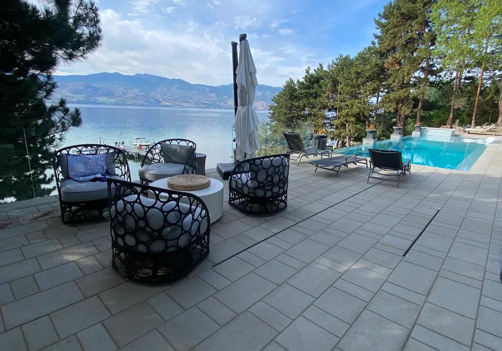 lake front property with chairs and pool