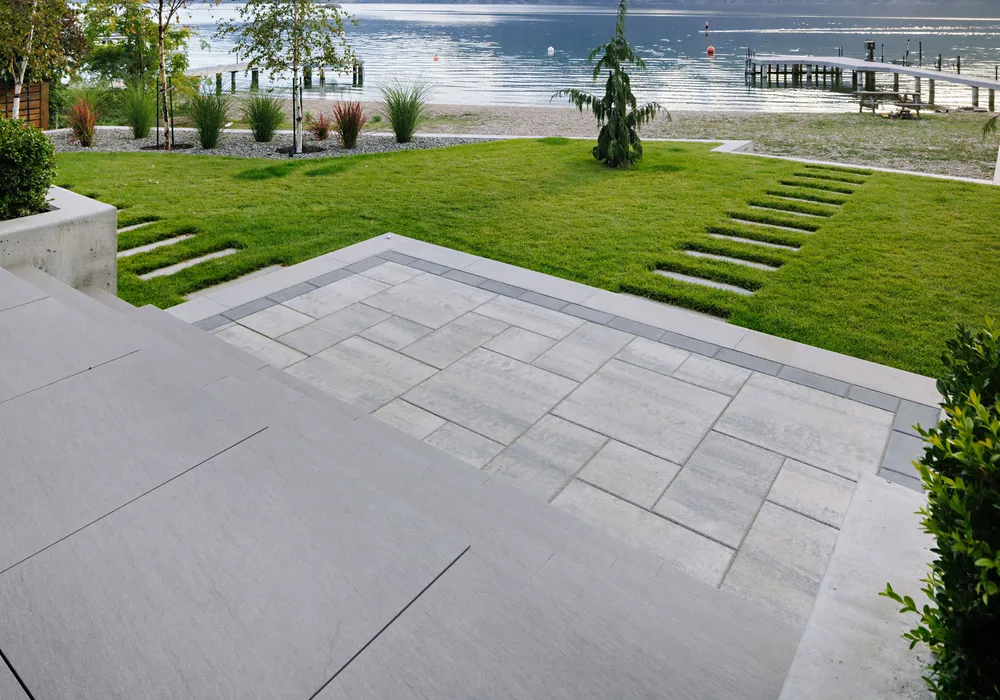 retaining wall and steps walkway green lawn lakefront home