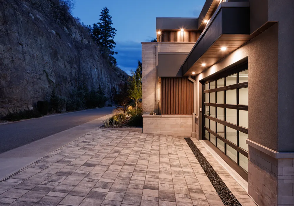 stone driveway and modern home night time lighting