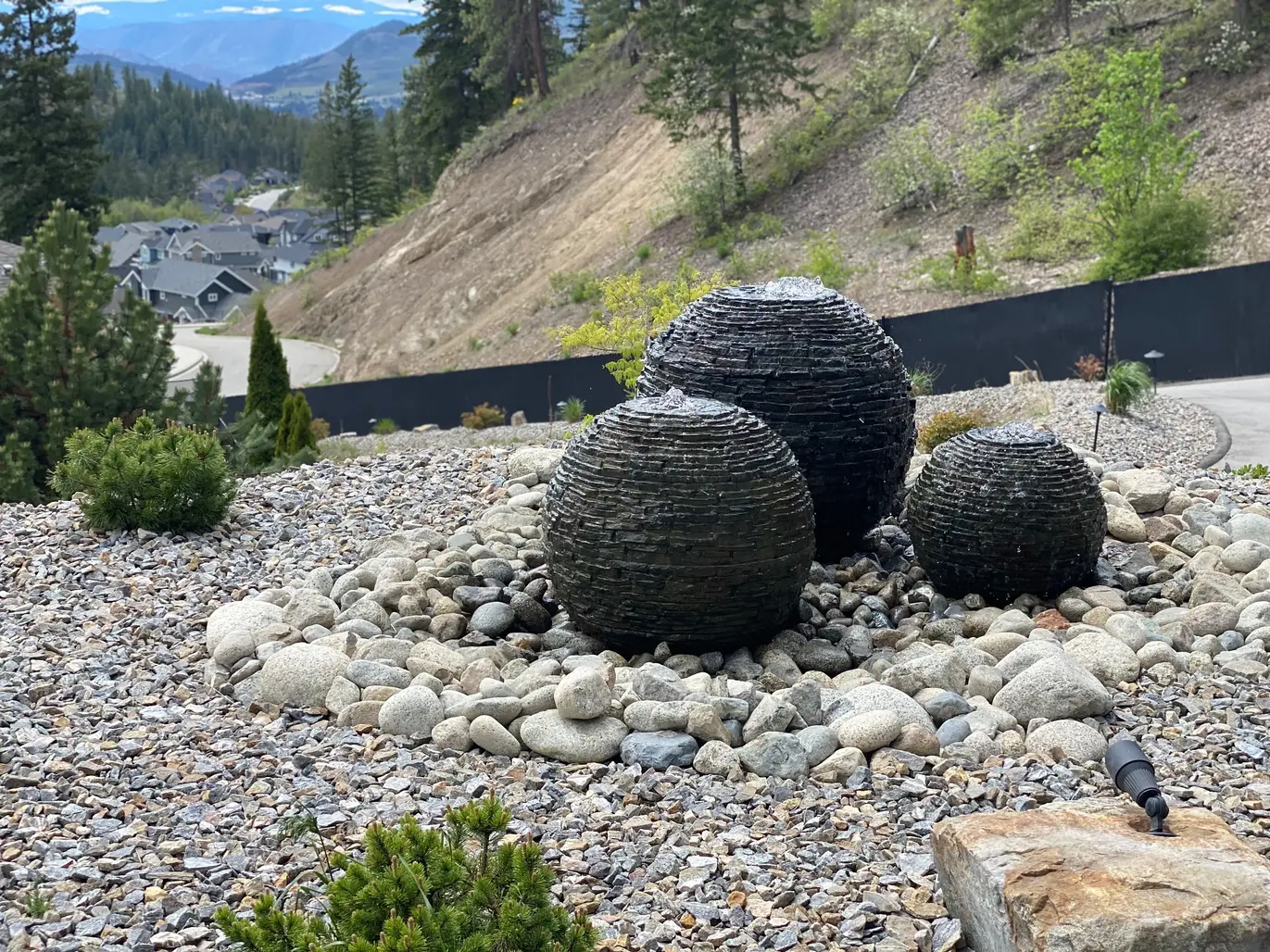 Water feature in the middle of a rocky landscape with a town in the background